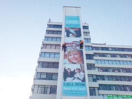 Advertising banner on a building install